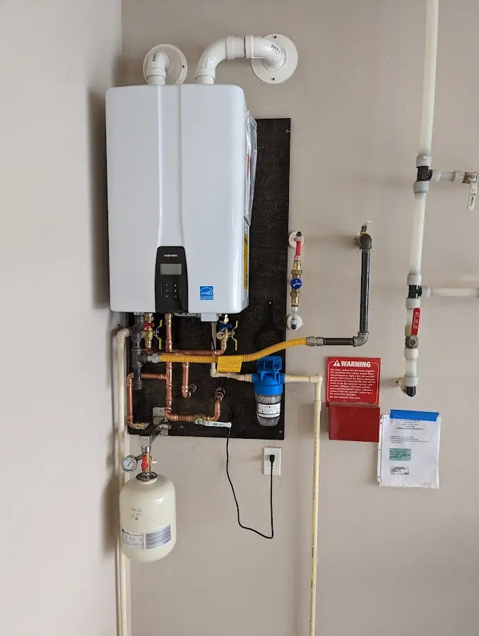 Professional plumber installing copper piping in a Purcellville home
